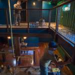 Dan Gowdy, top, and Eric Plummer work on the remodel of Roma (formerly known as Pizzeria Roma) on Tuesday, April 2, 2019. The restaurant will reopen the middle of April. (Michael Penn | Juneau Empire)