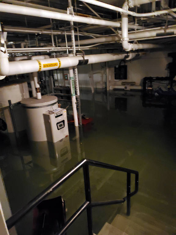 This photo shows flooding in the basement of the Marie Drake building on Friday, April 5, 2019. Flooding in a basement boiler room spread diesel fumes throughout the building. (Courtesy Photo | Chris Cairns)