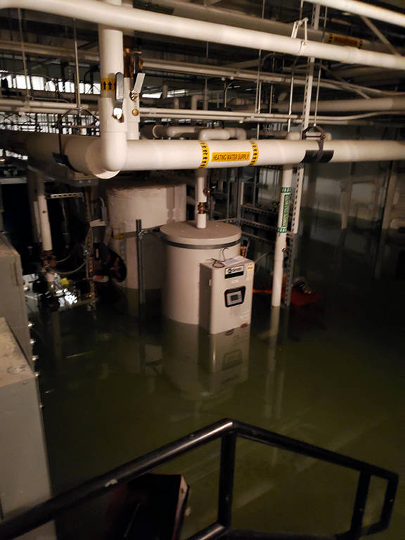 This photo shows flooding in the basement of the Marie Drake building on Friday, April 5, 2019. Flooding in a basement boiler room spread diesel fumes throughout the building. (Courtesy Photo | Chris Cairns)