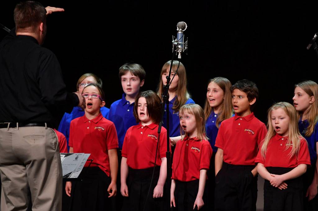 Members of the Alaska Youth Choir perform at the 45th annual Alaska Folk Festival at Centennial Hall on Monday, April 8, 2019. (Michael Penn | Juneau Empire)