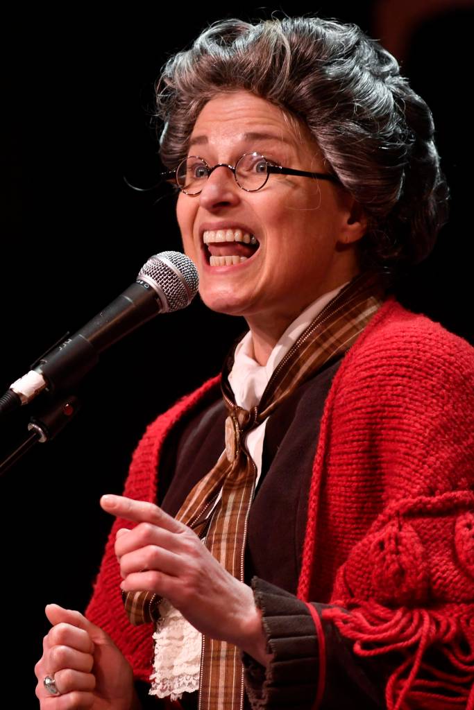 Patricia Hull, of Juneau, accompanied by Jon Hays, performs as The Most Dangerous Woman in America at the 45th annual Alaska Folk Festival at Centennial Hall on Monday, April 8, 2019. (Michael Penn | Juneau Empire)