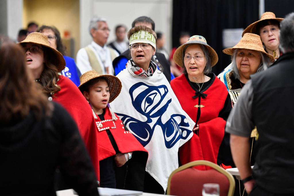 Members of the Xaadaas Dagwii Dance Group enter the Elizabeth Peratrovich Hall for the opening of the 84th annual Tribal Assembly of the Central Council of Tlingit and Haida Indian Tribes of Alaska on Wednesday, April 10, 2019. (Michael Penn | Juneau Empire)