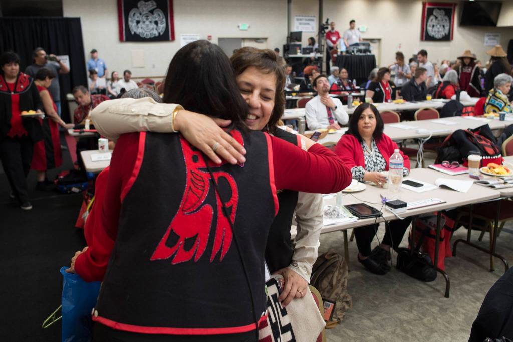 Delegates greet each other during the opening of the three day 84th annual Tribal Assembly of the Central Council of Tlingit and Haida Indian Tribes of Alaska at the Elizabeth Peratrovich Hall on Wednesday, April 10, 2019. (Michael Penn | Juneau Empire)