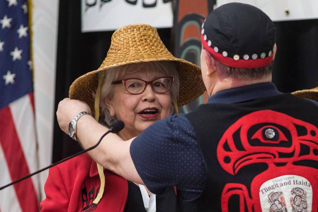 Tribal Hostess Cheryl Dodson receives a cedar hat from 4th Vice President Rob Sanderson during the opening of the 84th annual Tribal Assembly of the Central Council of Tlingit and Haida Indian Tribes of Alaska at the Elizabeth Peratrovich Hall on Wednesday, April 10, 2019. (Michael Penn | Juneau Empire)