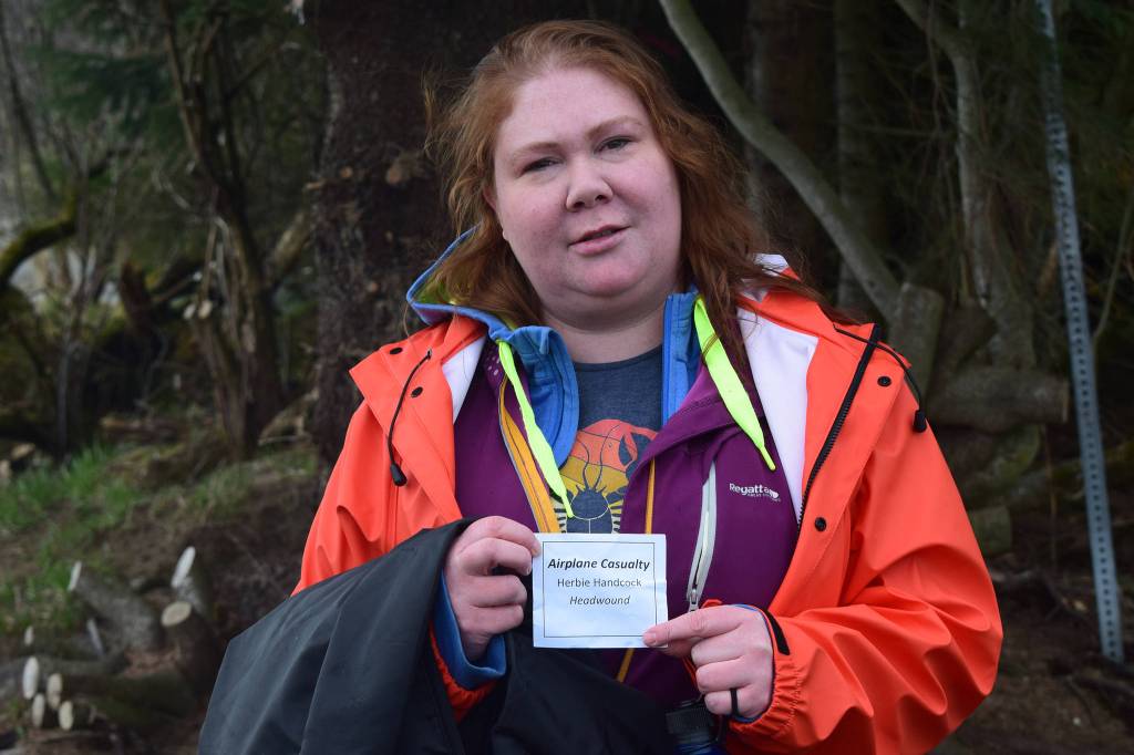 Volunteer Jessica Oliver displays her fake identity used in a emergency response exercise at the Mendenhall Wetlands State Game Refuge. (Nolin Ainsworth | Juneau Empire)