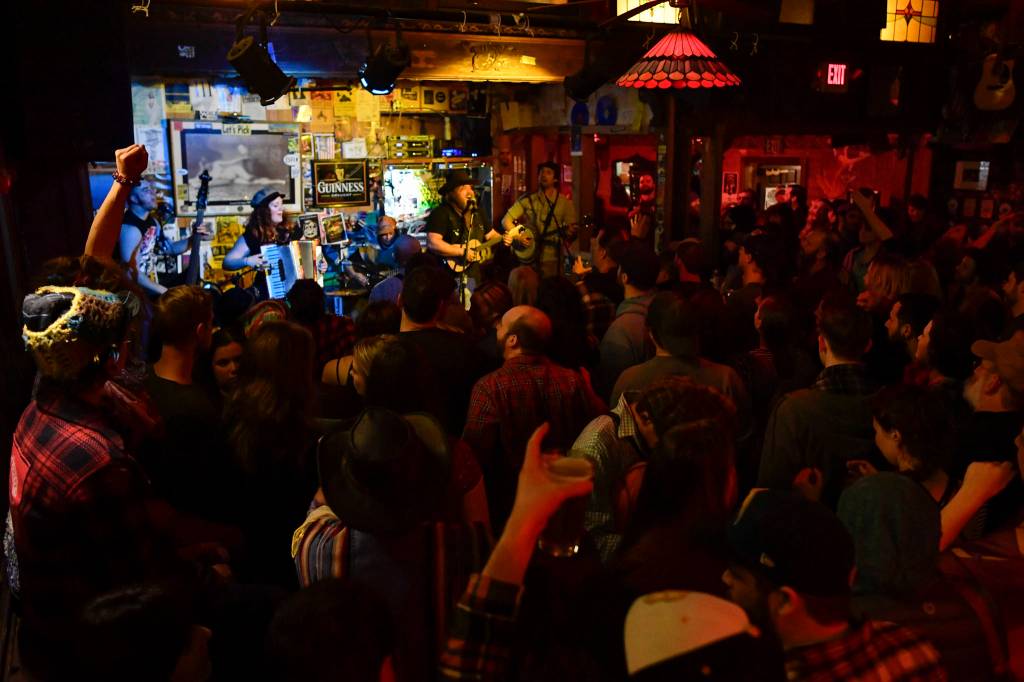 Bar patrons and music lovers catch The Shoot Dangs at the Alaskan Hotel & Bar during Alaska Folk Festival week on Friday, April 12, 2019. (Michael Penn | Juneau Empire)