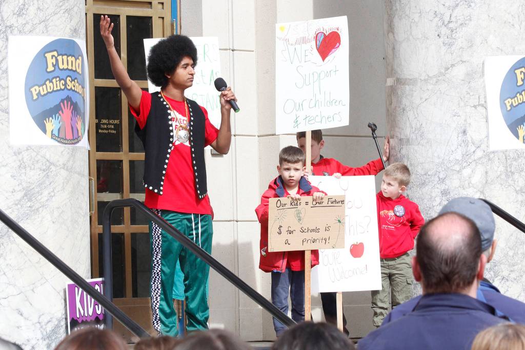 Juneau-Douglas High School senior Arias Hoyle speaks at the Fund Our Future rally on the steps of the Alaska State Capitol on Saturday. (Alex McCarthy | Juneau Empire)