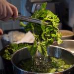 Erin Anais Heist prepares and bakes a khachapuri with nettles, feta and mozzarella cheese and topped with an egg on Friday, April 12, 2019. (Michael Penn | Juneau Empire)
