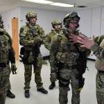 Sgt. Brian Dallas, right, sets up a drill as members of the Juneau Police Department and Capital City Fire/Rescue conduct a joint training exercise at the former Public Safety Building on Whittier Street on Tuesday, April 16, 2019. The training is designed to boost collaboration between CBJ law enforcement and emergency medical personnel. (Michael Penn | Juneau Empire)