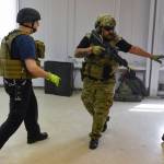 Juneau Police Department Officer Nick Garza, right, escorts Cory Hutchinson, of Capital City Fire/Rescue, as they conduct a joint training exercise at the former Public Safety Building on Whittier Street on Tuesday, April 16, 2019. The training is designed to boost collaboration between CBJ law enforcement and emergency medical personnel. (Michael Penn | Juneau Empire)