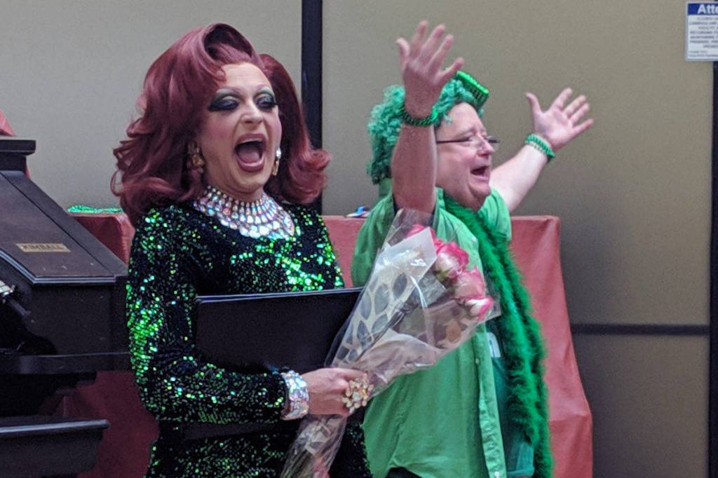 Gigi Monroe clutches a bouquet courtesy of organist T.J. Duffy after a St. Patricks Day organ concert at the State Office Building, Friday, March 15, 2019. (Ben Hohenstatt | Capital City Weekly)