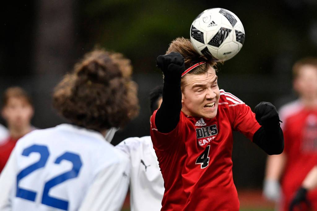 Juneau-Douglas William Hoover heads the ball against Thunder Mountain at Adair-Kennedy Memorial Field on Wednesday, April 17, 2019. Thunder Mountain won 2-1. (Michael Penn | Juneau Empire)