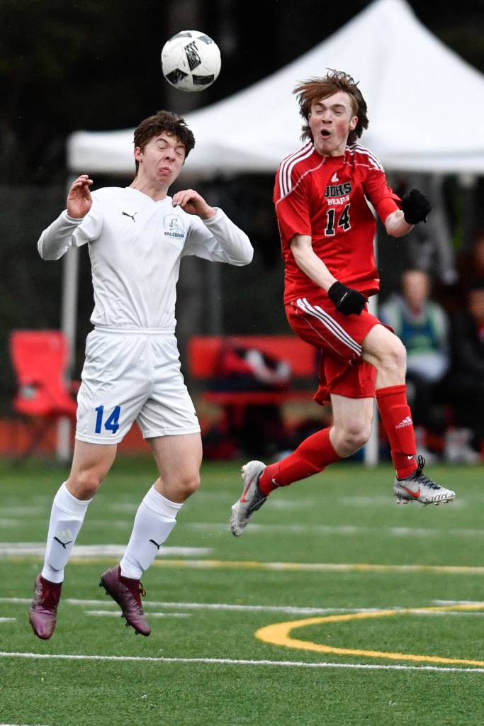Thunder Mountains Jake Babcock, left, and Juneau-Douglas Kanon Goetz battle to control the ball at Adair-Kennedy Memorial Field on Wednesday, April 17, 2019. Thunder Mountain won 2-1. (Michael Penn | Juneau Empire)