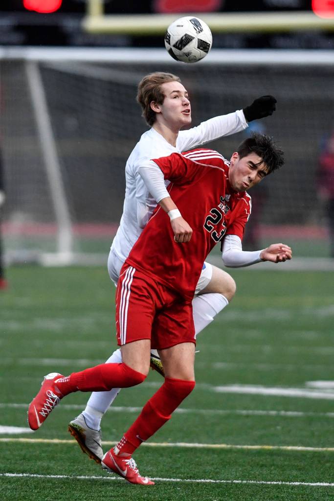 Thunder Mountains Wallace Adams, left, and Juneau-Douglas Kaiden Wilshusen attempt to control the ball at Adair-Kennedy Memorial Field on Wednesday, April 17, 2019. Thunder Mountain won 2-1. (Michael Penn | Juneau Empire)