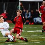 Thunder Mountains Wallace Adams kicks a goal against Juneau-Douglas William Hoover in the first half at Adair-Kennedy Memorial Field on Wednesday, April 17, 2019. Thunder Mountain won 2-1. (Michael Penn | Juneau Empire)