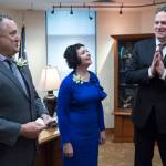 In this Jan. 15, 2019 photo, Sen. Mike Shower, R-Wasilla, left, and Sen. Shelley Hughes, R-Palmer, relay a message to Gov. Michael J. Dunleavy in his Capitol office that the Senate is open and ready for business on the first day of the 31st Session of the Alaska Legislature. (Michael Penn | Juneau Empire File)