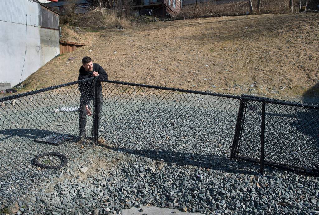 Dave McCasland, owner of Deckhand Daves Fish Tacos, takes down a section of fencing on Tuesday, April 2, 2019, as he prepares to move his food truck business onto the vacant lots that were formerly the Gastineau Apartments and Gunakadeit Park. The City and Borough of Juneau Assembly OKd an ordinance and a resolution that allows for a food court in the area. (Michael Penn | Juneau Empire)