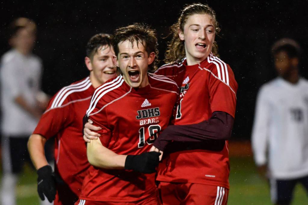 Juneau-Douglas Clem Taylor-Roth, center, celebrates his goal against Homer with teammates Richard Lehner, left, and Jackson Norberg at Adair-Kennedy Memorial Field on Friday, April 19, 2019. JDHS won 2-1. (Michael Penn | Juneau Empire)