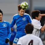 Thunder Mountains Wallace Adams heads the ball between his teammate Kellen Dumaop, left, and Ketchikans Apollo Jasper during their game on Friday, April 19, 2019. (Michael Penn | Juneau Empire)