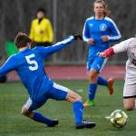 Juneau-Douglas Jackson Norberg dribbles around Thunder Mountains Elias West during their game at TMHS on Tuesday, April 23, 2019. JDHS won 2-0. (Michael Penn | Juneau Empire)
