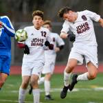 Juneau-Douglas Richard Lehner, right, heads a shot against Thunder Mountains Jake Babcock during their game at TMHS on Tuesday, April 23, 2019. JDHS won 2-0. (Michael Penn | Juneau Empire)
