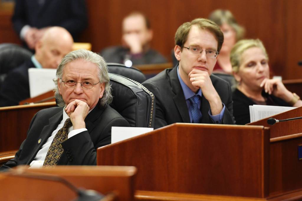 Sen. Tom Begich, D-Anchorage, left, Rep. Lance Pruitt, R-Anchorage, center, Rep. DeLena Johnson, R-Wasilla, and other legislators listen to debate for and against Amanda Price for commissioner of the Department of Public Safety during confirmation voting during a joint session of the Alaska Legislature at the Capitol on Wednesday, April 17, 2019. (Michael Penn | Juneau Empire)