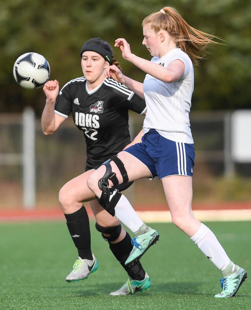 Juneau-Douglas Nikki Box, left, chases the ball against Soldotnas Kianna Holland at Adair-Kennedy Memorial Field on Friday, April 26, 2019. JDHS won 4-0. (Michael Penn | Juneau Empire)