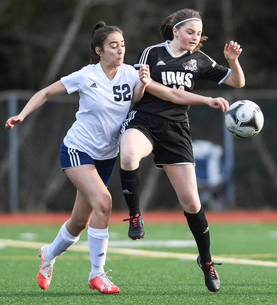 Juneau-Douglas Ella Goldstein, right, battles against Soldotnas Drysta Crosby-Schneider at Adair-Kennedy Memorial Field on Friday, April 26, 2019. JDHS won 4-0. (Michael Penn | Juneau Empire)