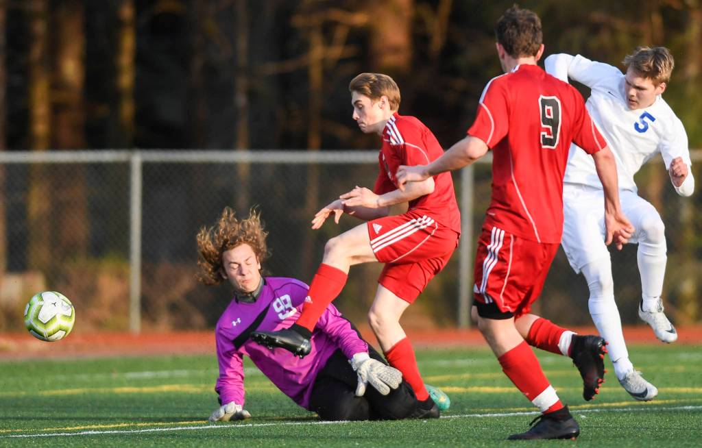 Juneau-Douglas Koby Goldstein shoots against Soldotnas goal keeper Hunter Woodward at Adair-Kennedy Memorial Field on Friday, April 26, 2019. JDHS won 6-0. (Michael Penn | Juneau Empire)
