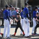 Players run a gauntlet of Thunder Mountain High School baseball and softball team players during the Gastineau Channel Little League Opening Day Ceremonies at Adair-Kennedy Memorial Park on Saturday, April 27, 2019. (Michael Penn | Juneau Empire)