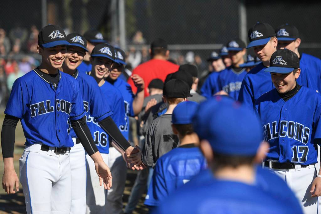 Players run a gauntlet of Thunder Mountain High School baseball and softball team players during the Gastineau Channel Little League Opening Day Ceremonies at Adair-Kennedy Memorial Park on Saturday, April 27, 2019. (Michael Penn | Juneau Empire)