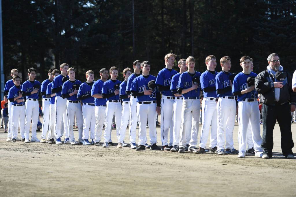The Thunder Mountain High School baseball team watches during Gastineau Channel Little League Opening Day Ceremonies at Adair-Kennedy Memorial Park on Saturday, April 27, 2019. (Michael Penn | Juneau Empire)