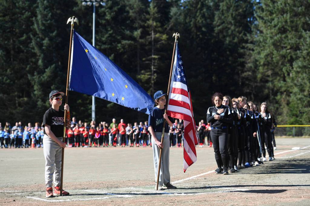 Jake and John Polasky present the colors during the Gastineau Channel Little League Opening Day Ceremonies at Adair-Kennedy Memorial Park on Saturday, April 27, 2019. (Michael Penn | Juneau Empire)