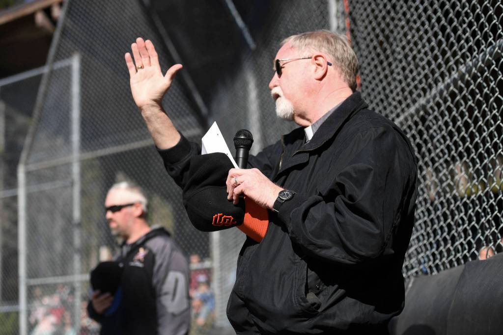 Deacon Charles Rohrbacher, of the Diocese of Juneau, sends out a blessing during the Gastineau Channel Little League Opening Day Ceremonies at Adair-Kennedy Memorial Park on Saturday, April 27, 2019. (Michael Penn | Juneau Empire)