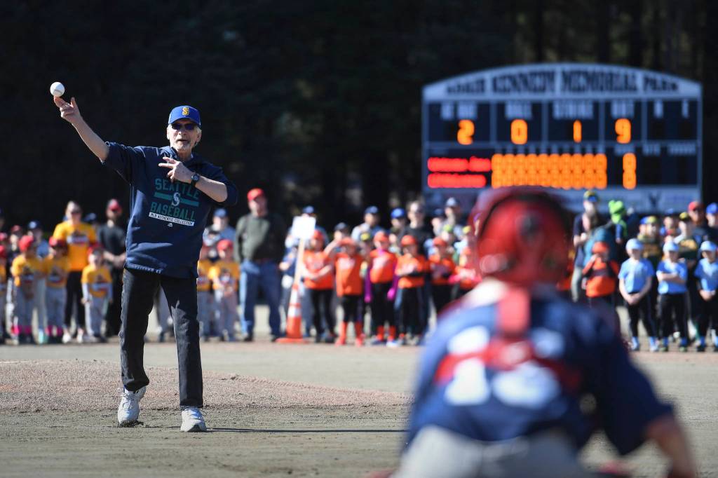 Paul Jones throws out the first baseball pitch to catcher Christian Nelson during the Gastineau Channel Little League Opening Day Ceremonies at Adair-Kennedy Memorial Park on Saturday, April 27, 2019. (Michael Penn | Juneau Empire)