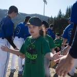 Players run a gauntlet of Thunder Mountain High School baseball and softball team players during the Gastineau Channel Little League Opening Day Ceremonies at Adair-Kennedy Memorial Park on Saturday, April 27, 2019. (Michael Penn | Juneau Empire)