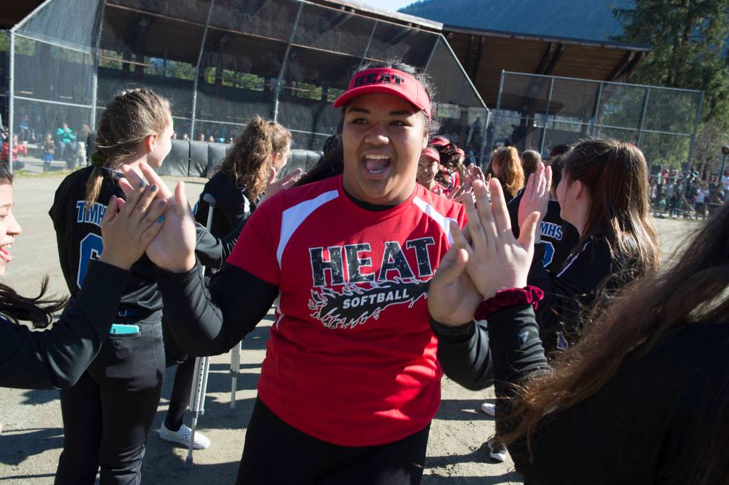 Players run a gauntlet of Thunder Mountain High School baseball and softball team players during the Gastineau Channel Little League Opening Day Ceremonies at Adair-Kennedy Memorial Park on Saturday, April 27, 2019. (Michael Penn | Juneau Empire)