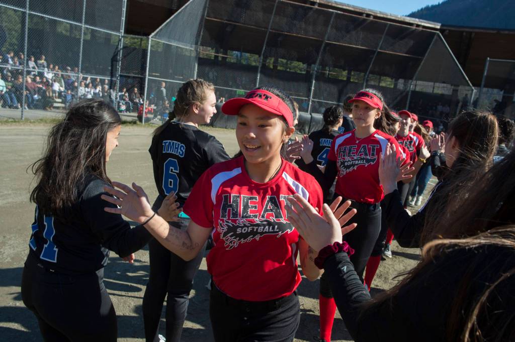 Players run a gauntlet of Thunder Mountain High School baseball and softball team players during the Gastineau Channel Little League Opening Day Ceremonies at Adair-Kennedy Memorial Park on Saturday, April 27, 2019. (Michael Penn | Juneau Empire)