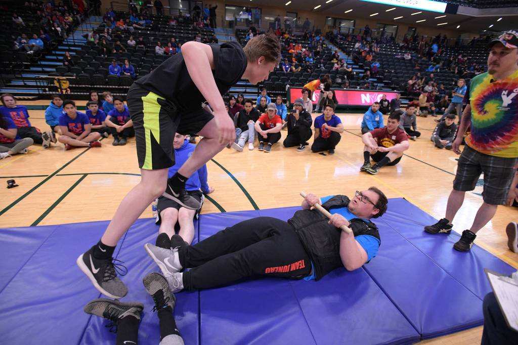 Thunder Mountain High School senior Sterling Zuboff competes the Eskimo stick pull at the 2019 NYO Games at the Alaska Airlines Center in Anchorage, Alaska, on Friday, April 26, 2019. (Michael Dinneen | For the Juneau Empire)