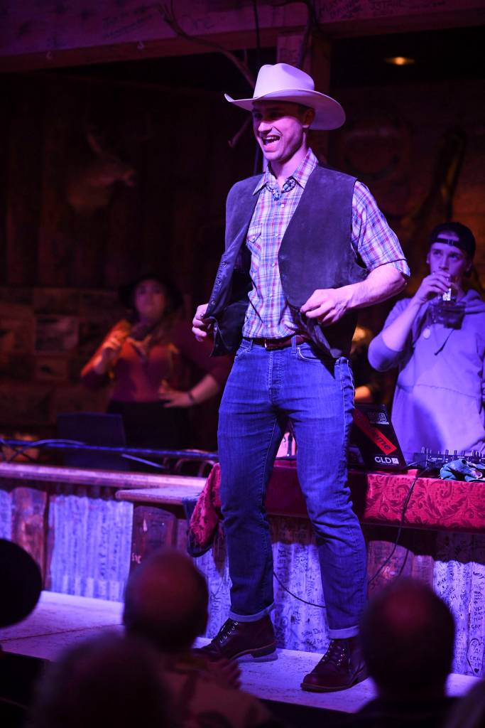 Mens and womens clothing from Downtown Dames Resale Shop is modeled on stage during the Juneau Rotaracts Wild West Roundup Fashion Show at the Red Dog Saloon on Saturday, April 27, 2019. (Michael Penn | Juneau Empire)