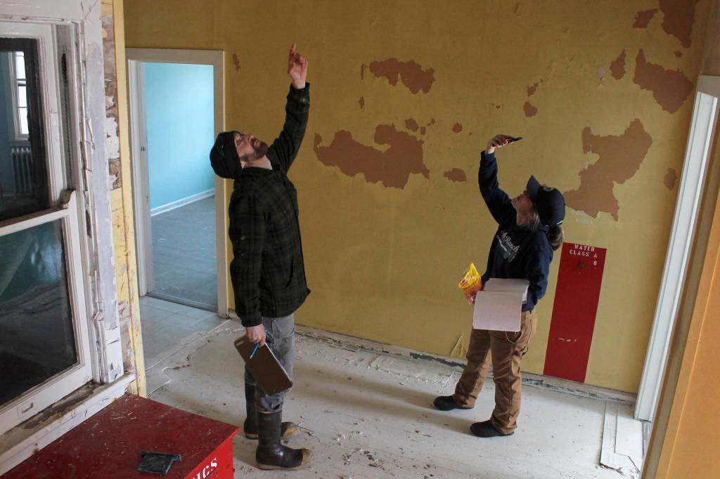 Eldred Rock Lighthouse Preservation Association Executive Director Sue York and board member Justin Fantasia examine Eldred Rock Lighthouse on Monday, April 29, 2019. (Alex McCarthy | Juneau Empire)