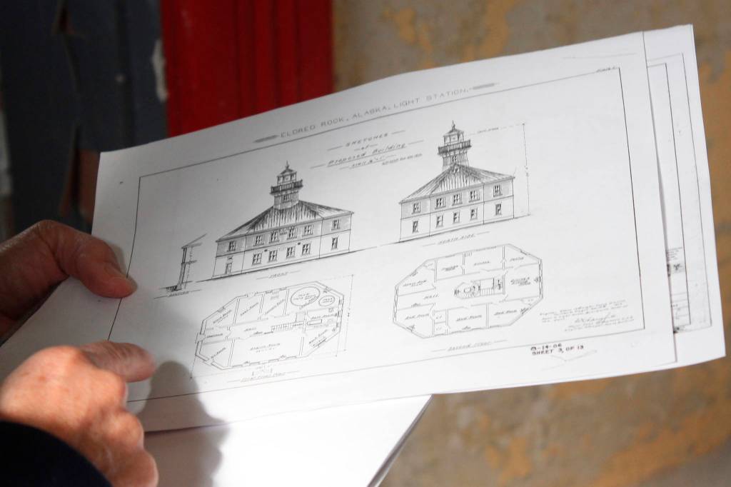 Eldred Rock Lighthouse Preservation Association Executive Director Sue York consults diagrams at Eldred Rock Lighthouse on Monday, April 29, 2019. (Alex McCarthy | Juneau Empire)