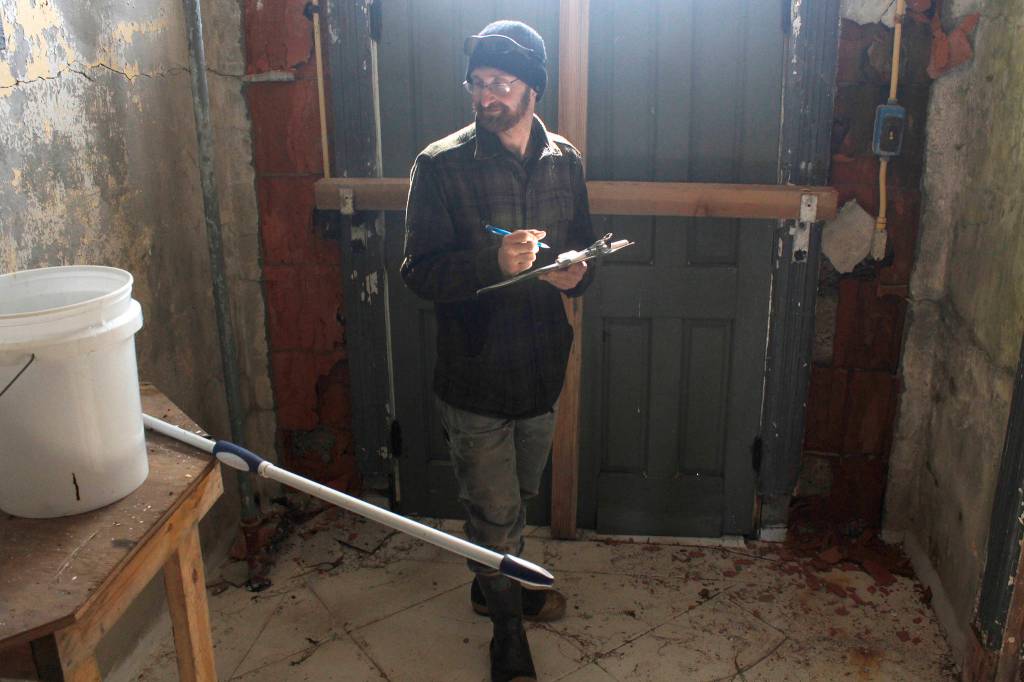Eldred Rock Lighthouse Preservation Association board member Justin Fantasia takes notes at Eldred Rock Lighthouse on Monday, April 29, 2019. (Alex McCarthy | Juneau Empire)