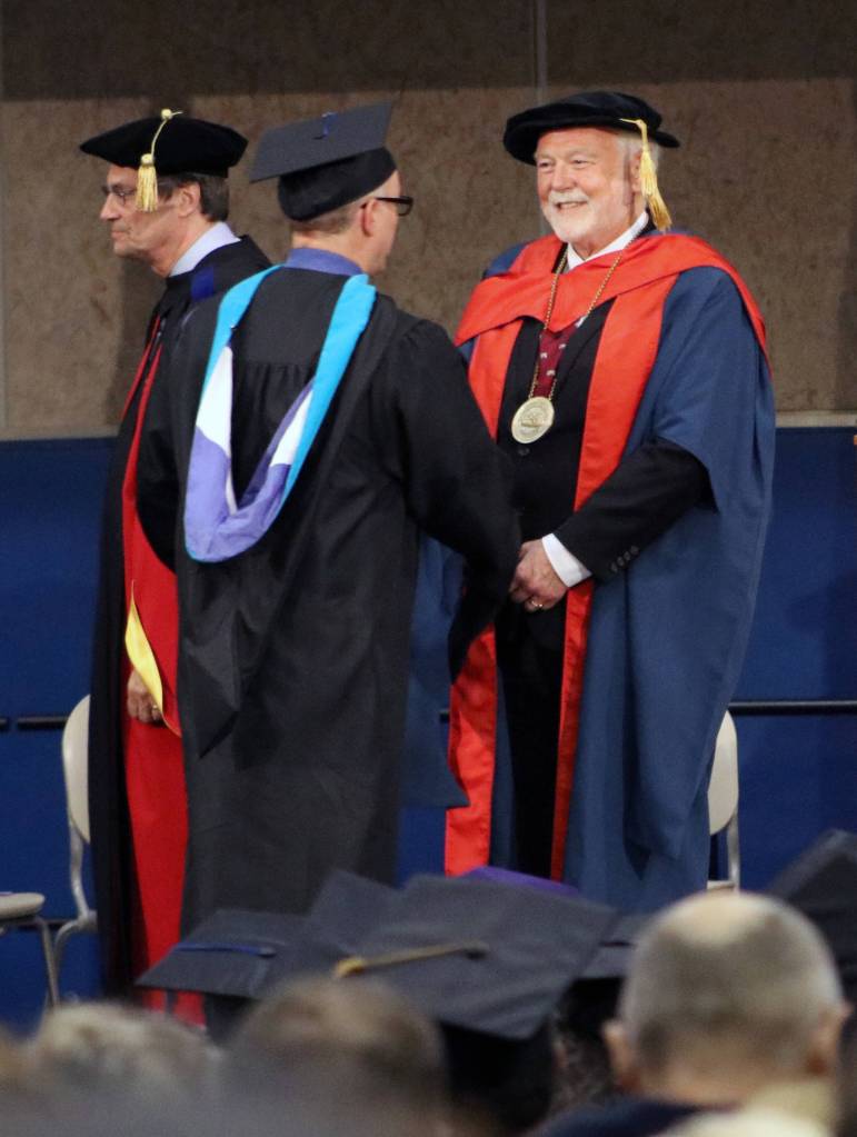 University of Alaska Southeast Chancellor Richard Caulfield congratulates a graduate during the UAS commencement ceremony on Sunday, May 5, 2019. We are enormously proud of our graduates at all three UAS campuses. Many of our students are first-generation college students and are completing their degree while raising a family and working one or two jobs. Every one of them chose to advance their skills and education at UAS as a pathway to improving their life and that of their family and community, Caulfield said. (Erin Laughlin | For the Juneau Empire)