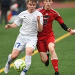 Thunder Mountains Logan Miller, left, moves the ball against Juneau-Douglas Koby Goldstein at Adair-Kennedy Memorial Field on Tuesday, May 7, 2019. The game ended tied at 1-1. (Michael Penn | Juneau Empire)