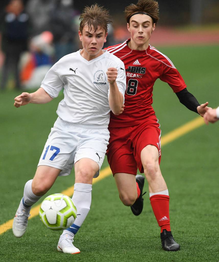 Thunder Mountains Logan Miller, left, moves the ball against Juneau-Douglas Koby Goldstein at Adair-Kennedy Memorial Field on Tuesday, May 7, 2019. The game ended tied at 1-1. (Michael Penn | Juneau Empire)