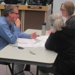 City Manager Rorie Watt and Assembly members Michelle Bonnet Hale and Carole Triem work out an amendment to proposed Marine Passenger Fee spending. (Ben Hohenstatt | Juneau Empire)