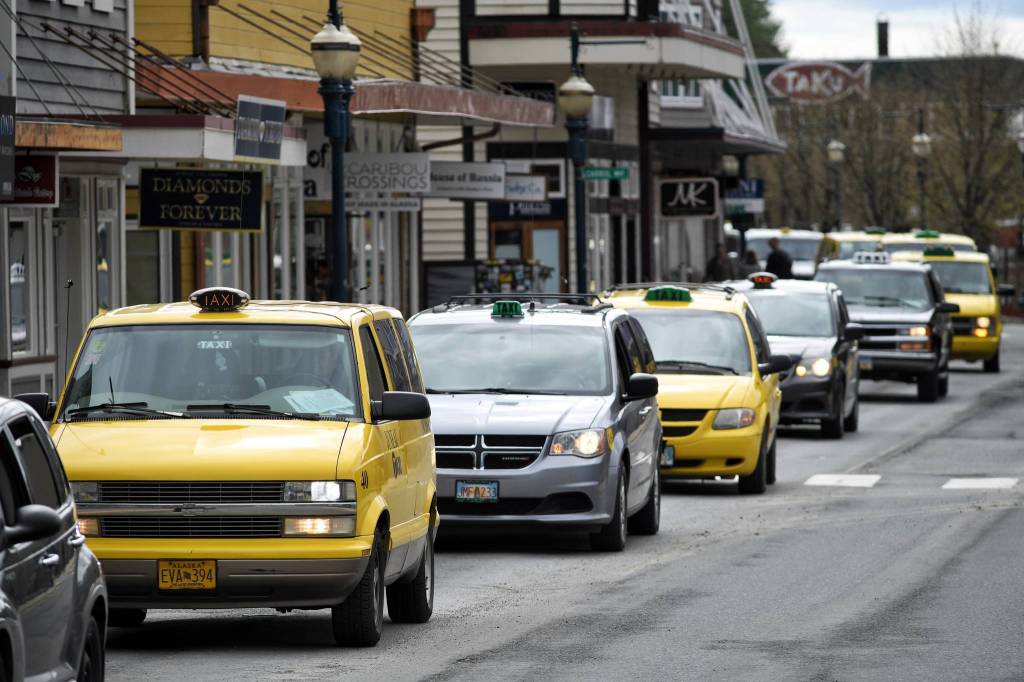 Juneau taxi drivers parade through downtown Juneau in honor of Scott Campbell on Friday, May 10, 2019. (Michael Penn | Juneau Empire)