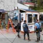Dave McCasland, owner of Deckhand Daves Fish Tacos, center, talks with Eric Plummer, left, and Brennen Brewer, of Peak Construction, as they set up food truck businesses at Gunakedeit Park, also known as Pocket Park, on Thursday, May 9, 2019. The businesses are expected to be open by Monday. (Michael Penn | Juneau Empire)