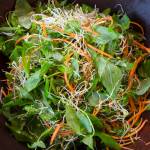 Erin Anais Heist prepares twisted stalk salad to go with crab cakes on Friday, May 10, 2019. (Michael Penn | Juneau Empire)